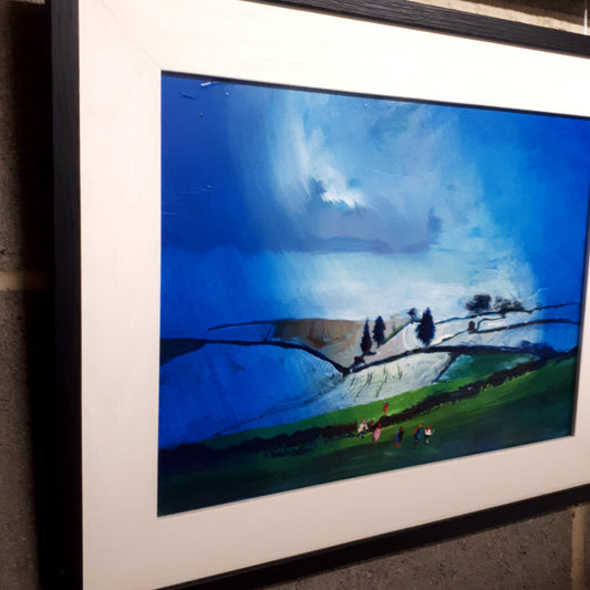 Framed original landscape painting juxtaposed with a small group of walkers.